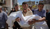 Nabil Abu Labda carries the body of his 6-year-old daughter, Menna Allah Abu Labda, who was killed in an Israeli airstrike.