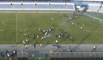Football fans storm field in Libya and a Portuguese referee is injured during a suspended match