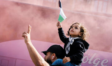 A child holds a Palestinian flag as protesters attend a demonstration called “All of Denmark on the streets for a free Palestine