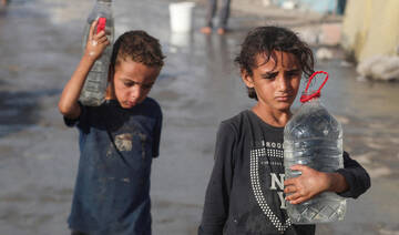 Palestinian children walk with water amid shortages, in Gaza City, September 3, 2025. (Reuters)