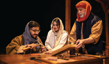 The team at ‘Ikmah After Dark: Secrets of the Scribe’ showing a visitor how to carve on a  stone. (Supplied)