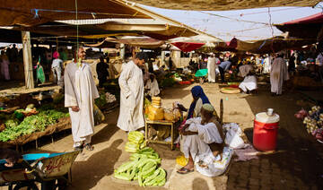 Customers buy vegetables at a market in Omdurman, on the outskirts of Khartoum, Sudan, Sunday, April 26, 2026. (AP)