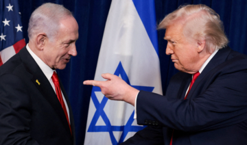 US President Donald Trump points his finger toward Israeli Prime Minister Benjamin Netanyahu as they shake hands.