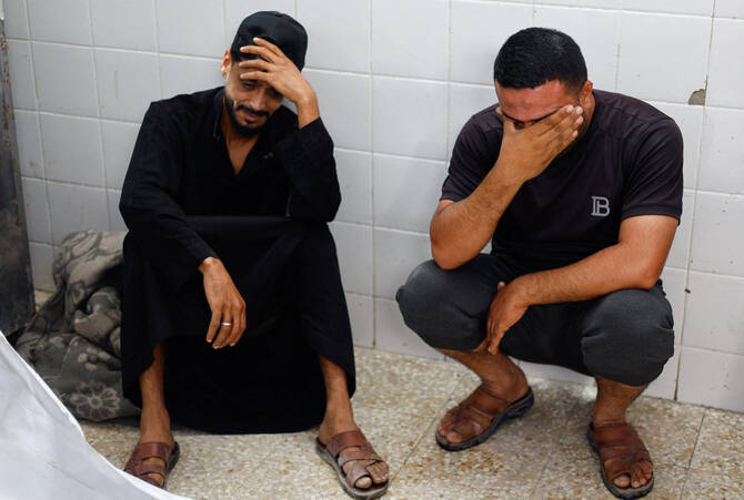 Mourners react during the funeral of brothers Saqer and Moumen Al-Aydi, who were killed in an Israeli strike.